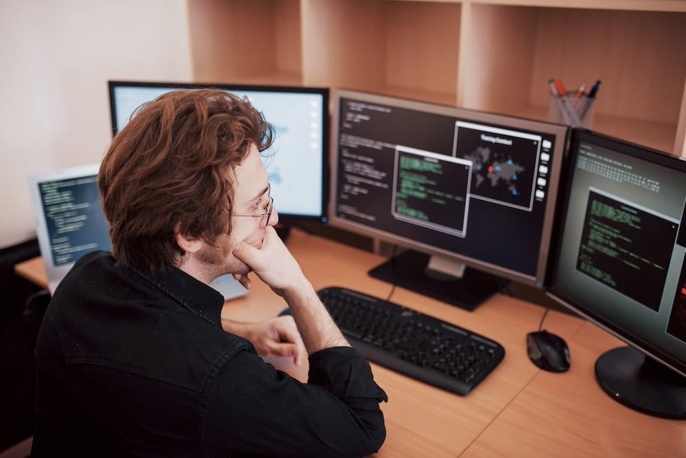 male-programmer-working-on-desktop-computer-with-m-2023-11-27-05-15-55-utc